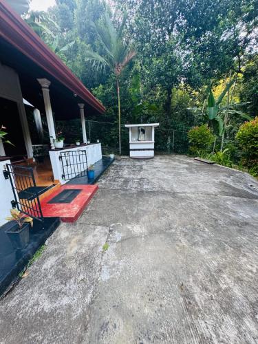 a patio of a house with a red bench at Thotupala Villa in Nikawatawana