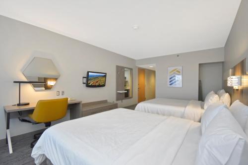a hotel room with two beds and a desk at Holiday Inn Express Boone by IHG in Boone