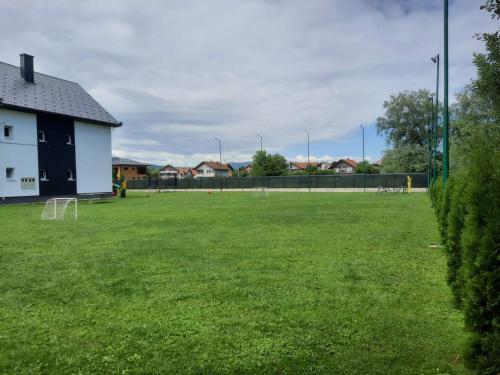 a large grassy field with a soccer field at The Bosna River in Vreoca