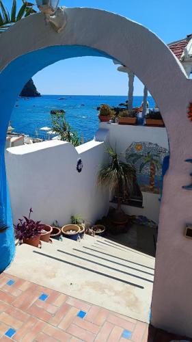an archway with potted plants and a view of the ocean at Appartamenti Tina in Villa Restituta in Ischia