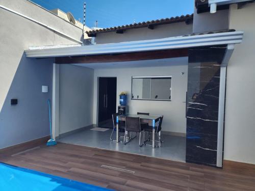 a patio with a table and chairs next to a swimming pool at Casa Bahia Farm Show in Luis Eduardo Magalhaes
