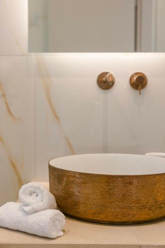 a bathroom with a sink and towels on a counter at KALIMERA Luxurious Villas in Lixouri