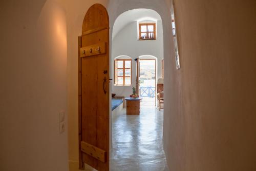 a hallway with an open door in a house at Aegea Cave Houses in Mesaria