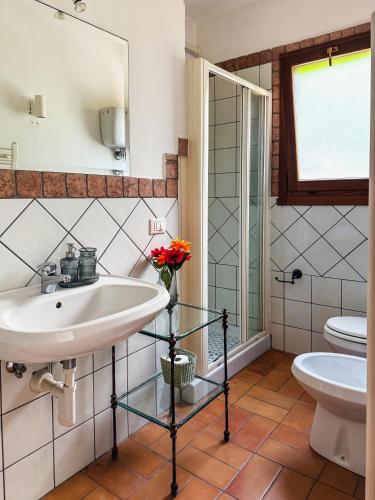 a bathroom with a sink and a toilet at Casa Petra in Itri