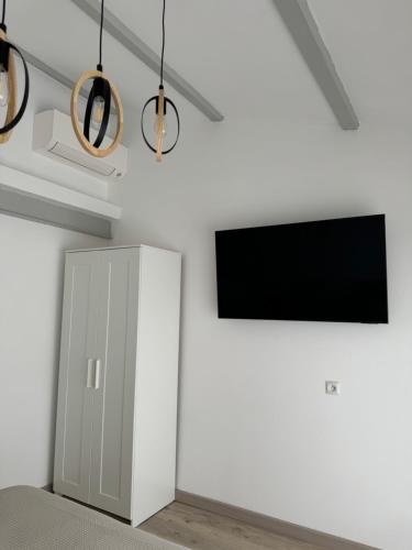 a living room with a tv and a cabinet at Villa hortensia in Carpentras