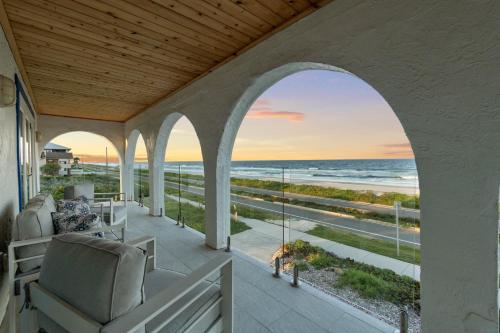 an arched porch with a view of the ocean at Salty Greek in Flagler Beach