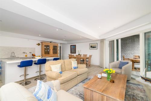 a living room with a couch and a table at Luxury Apartment very close to Tolcarne Beach in Newquay
