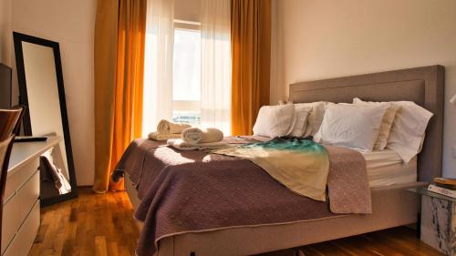 a bedroom with a bed with towels on it at Villa Campagna in Trogir