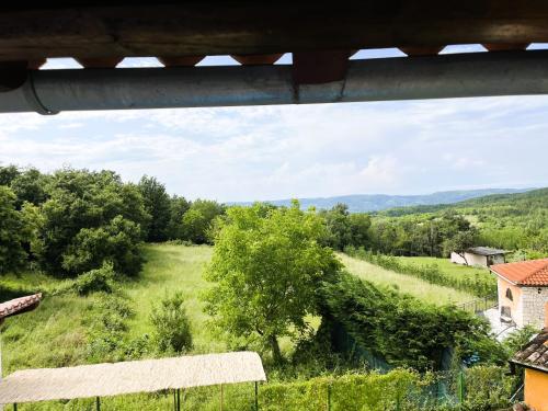 a view of a field with trees and a house at Villa Caroiba in Karojba