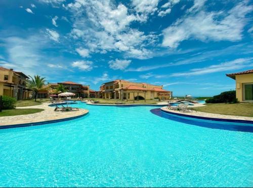 a pool with blue water in a resort at Búzios Beach Resort in Búzios