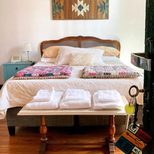 a bed with three folded towels on top of it at Rincón Colonial in Colonia del Sacramento