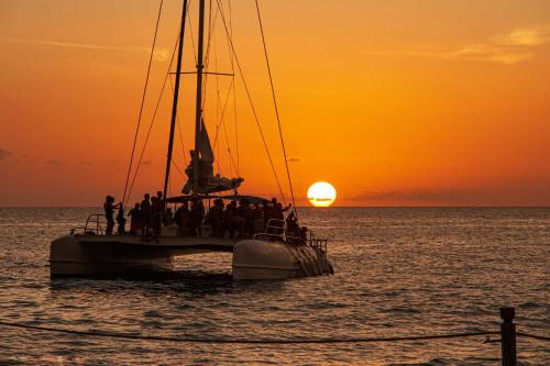 a group of people on a boat in the ocean at sunset at Infinity Pools & Sunsets Over Tamarindo Bay in Tamarindo