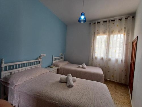a bedroom with two beds with stuffed animals on them at La Font Moraira in Moraira