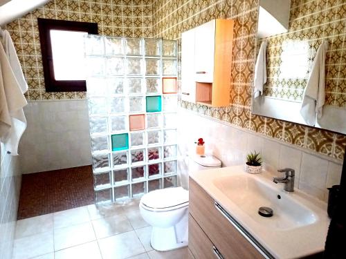 a bathroom with a toilet and a sink at La Font Moraira in Moraira