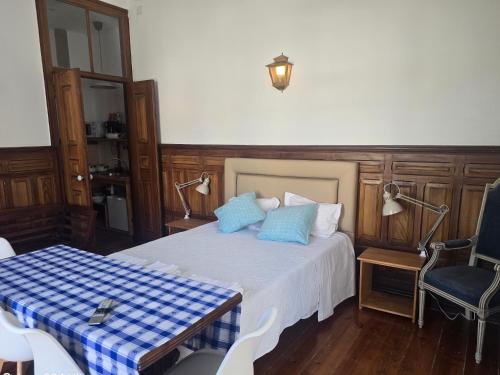 a bedroom with a bed with blue pillows on it at IN SETUBAL apartaments in Setúbal