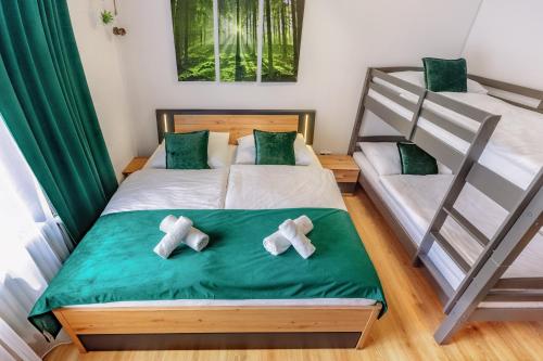 a bedroom with two bunk beds with crosses on the bed at Englmar Apartments with free WELLNESS and FITNESS in Sankt Englmar