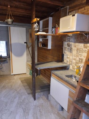 a kitchen with a counter and a sink at Cabana Hostel Guarulhos in Guarulhos