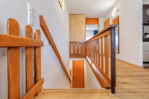 a hallway with wooden stairs in a house at Englmar Apartments with free WELLNESS and FITNESS in Sankt Englmar