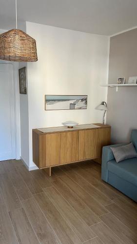 a living room with a couch and a table at Enhorabona Beach House in Alghero