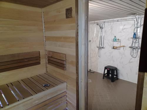 a sauna with a bench and a shower at countryside next to center in Kemi