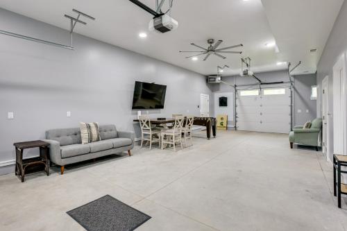 a living room with a couch and a table at Higgins Lake Barndominium with Boat Parking! in Higgins Lake