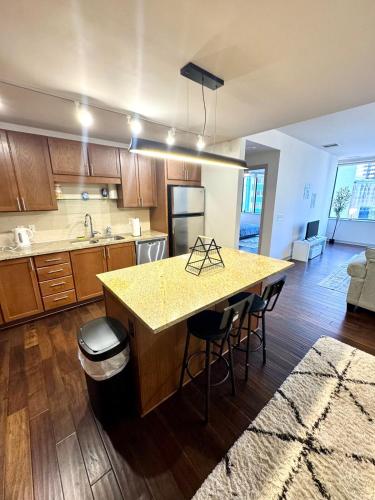 a kitchen with a island in the middle of a room at High-Rise Apartment in Downtown Dallas wPool in Dallas