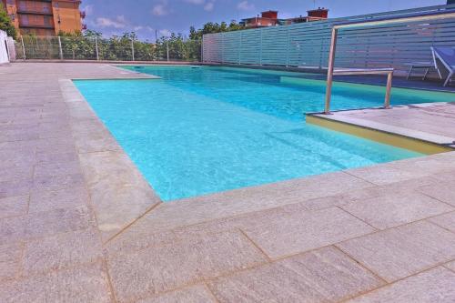 a swimming pool with blue water in a building at Marina Resort - Pool And Parking LUX - Happy Rentals in Borghetto Santo Spirito