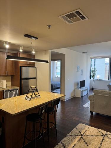 a kitchen and living room with a table and a couch at High-Rise Apartment in Downtown Dallas wPool in Dallas