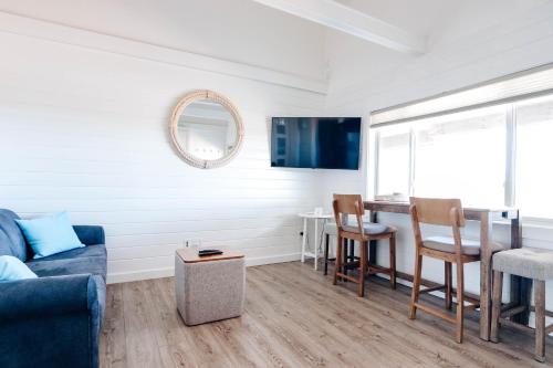 a living room with a couch and a table at Driftwood Resort on the Ocean in Montauk