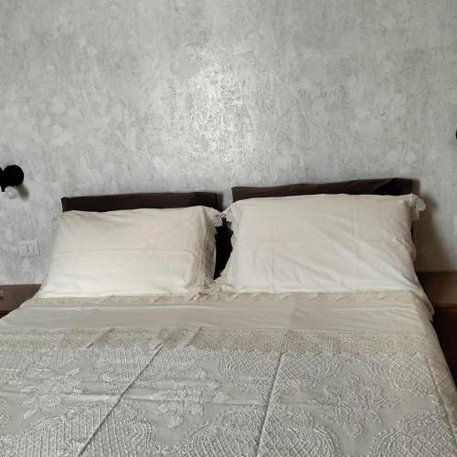 a bed with white sheets and pillows in a bedroom at Casa Rurale Pietra Bianca in Roccamorice