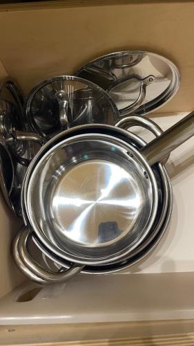 a pile of silver pans and utensils in a drawer at Mario house Assisi in Assisi