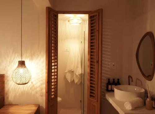 a bathroom with a tub and a sink and a mirror at Couples Suites at Ocean Park Beach Club in San Juan