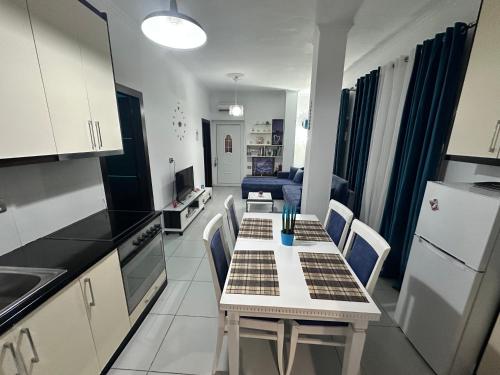 a kitchen with a table and chairs in a room at Vila Reni Risi in Ksamil