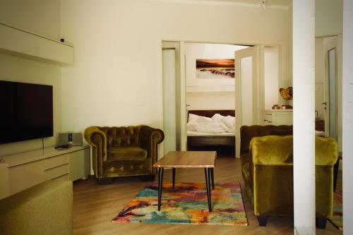 a living room with chairs and a tv and a table at Apartment in Berlin-Köpenick in Berlin