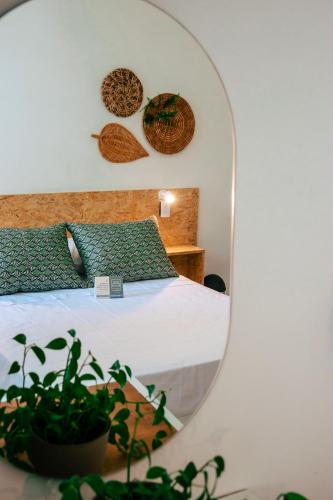 a bedroom with a bed and a mirror at Centro Hostel Medellin in Medellín