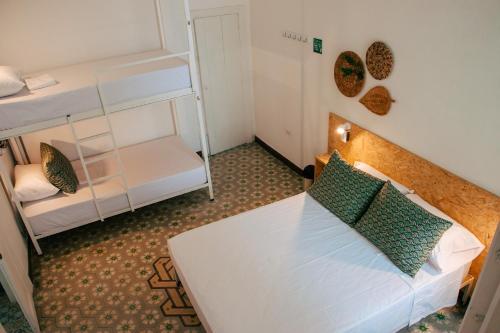 a small room with a bed and a bunk bed at Centro Hostel Medellin in Medellín