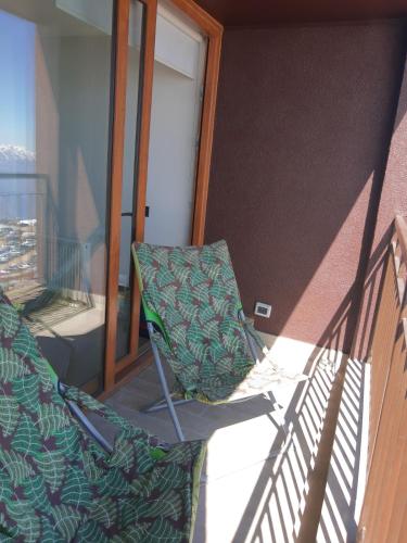 a pair of chairs sitting on a balcony at Gran Parador, El Colorado, ski in-out in Santiago
