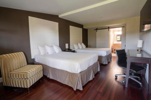 a hotel room with two beds and a desk at Hershey Farm Resort in Ronks
