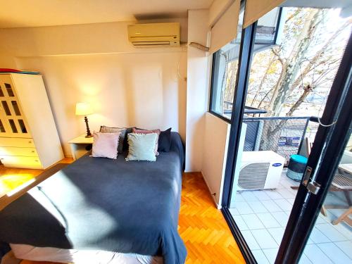 a room with a bed in the middle of a room at Apartamento con Piscina, cochera, loundry y gim en Palermo in Buenos Aires