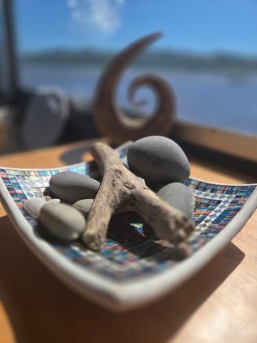 a plate topped with rocks and a star on a table at Liquid PARIDISE Noosaville houseboat "Experience More" in Noosa Heads