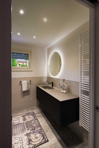 a bathroom with a sink and a mirror at Agrialloggio Reggenza in Cappella Maggiore