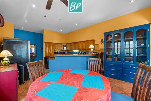 a dining room with a table and a kitchen at Casa Rodeo - Golden Zone Villa with Large Pool & Rooftop Ocean Views in Bucerías