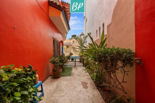 an alley between two buildings with potted plants at Casa Rodeo - Golden Zone Villa with Large Pool & Rooftop Ocean Views in Bucerías