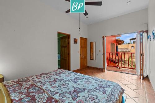 a bedroom with a bed and a view of a balcony at Casa Rodeo - Golden Zone Villa with Large Pool & Rooftop Ocean Views in Bucerías
