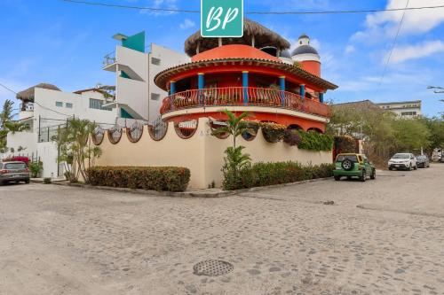 a building with a sign on top of it at Casa Rodeo - Golden Zone Villa with Large Pool & Rooftop Ocean Views in Bucerías