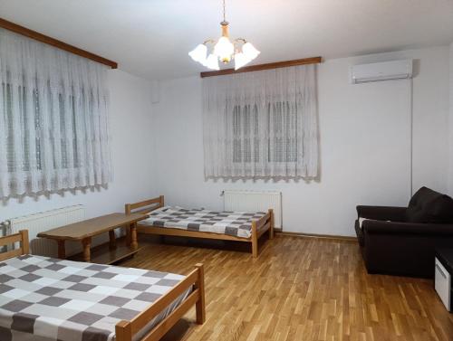 a living room with two beds and a couch at Villa Majida Ilidža in Sarajevo