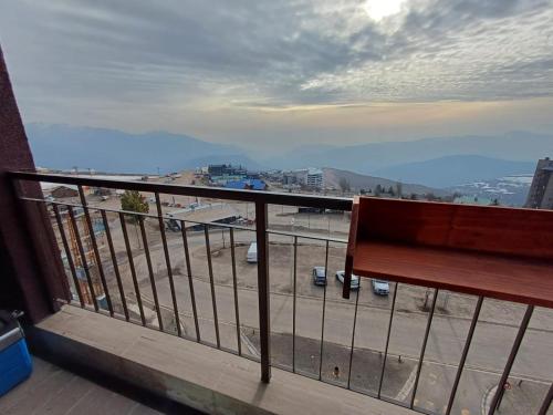 a bench on a balcony with a view of a city at Gran Parador, El Colorado, ski in-out in Santiago