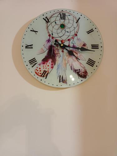 a clock is hanging on a wall at Stefkas apartment2 in Patra