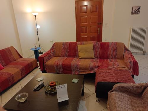 a living room with a couch and a coffee table at Stefkas apartment2 in Patra