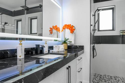 a bathroom with a black counter top and a shower at Marco Luxe Retreat Waterfront in Marco Island